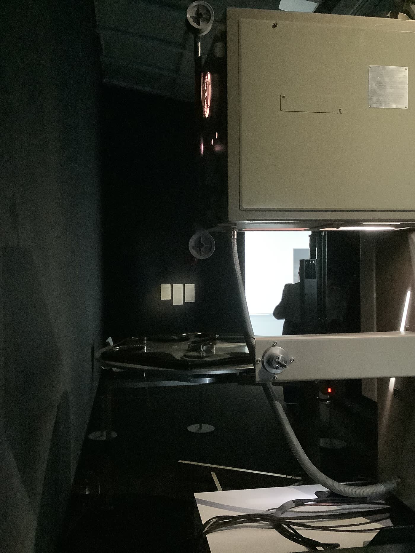 A large film reel mounted on a cinema projector